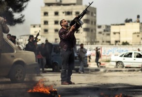 A Palestinian fires a weapon in the air during the funeral of Islamic Jihad militant Mohammed Daher in Gaza City